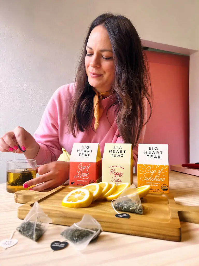 A woman brewing tea in a cuo from Big Heart Teas