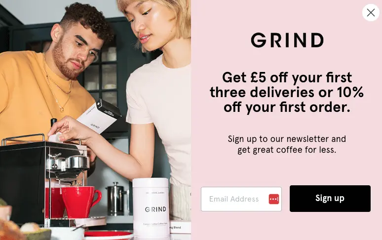 Image shows an email pop-up from coffee brand Grind, featuring a retro-styled photo of a couple brewing a cup of their coffee on the left, and the sign-up form fields and details on a pale pink background on the right.